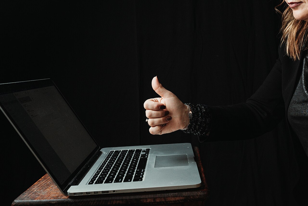 Happy client giving a thumbs up after their computer was fixed