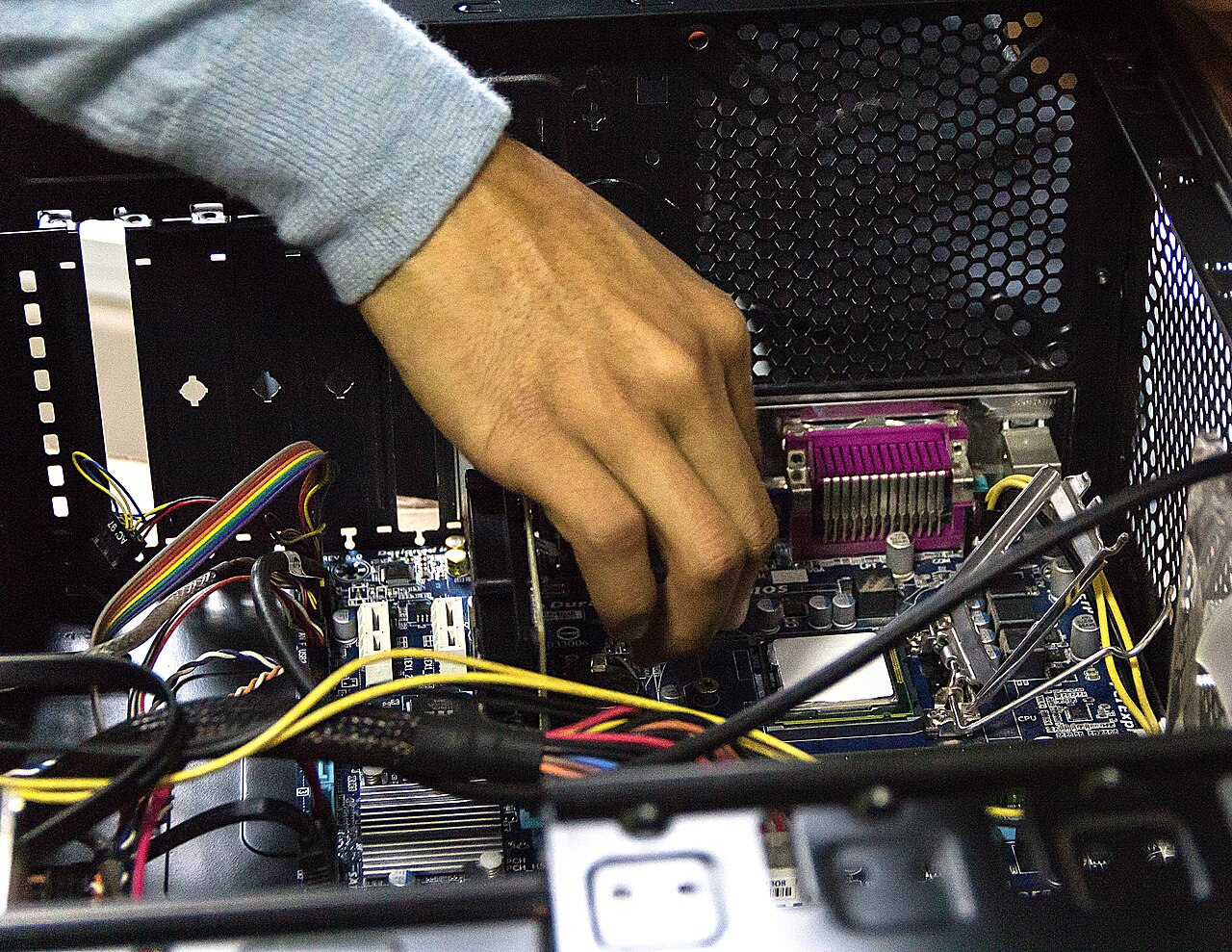 Technician fitting components inside a desktop PC